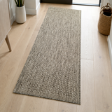 Taupe brown plain runner rug in a hallway interior