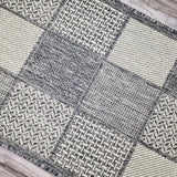 Grey check runner rug in a modern hallway interior